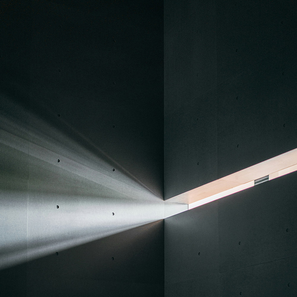 A cracked concrete wall with light coming through, representing visible structural problems