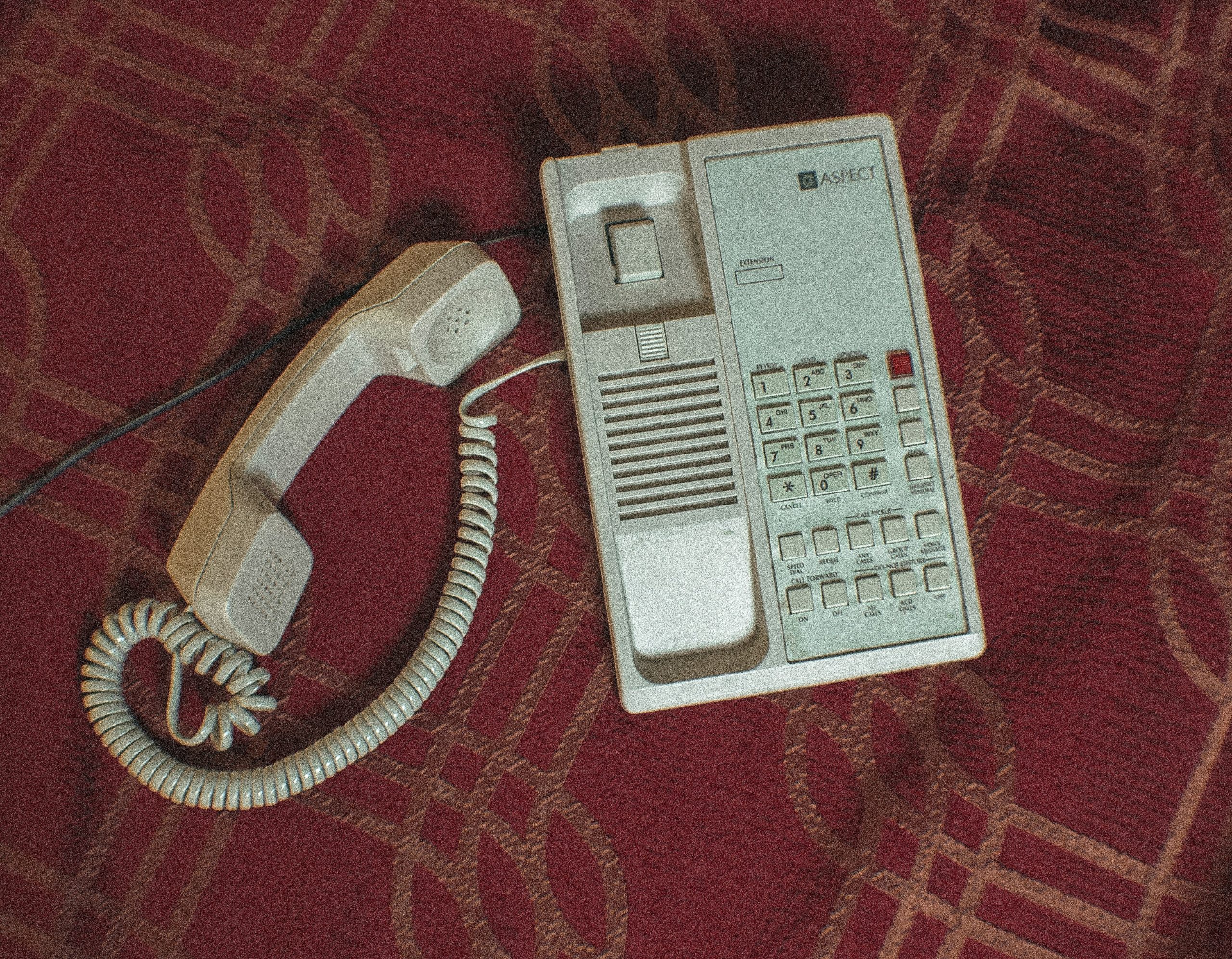 an unanswered desk phone, a glowing incoming-call light, or a phone receiver left off the hook.